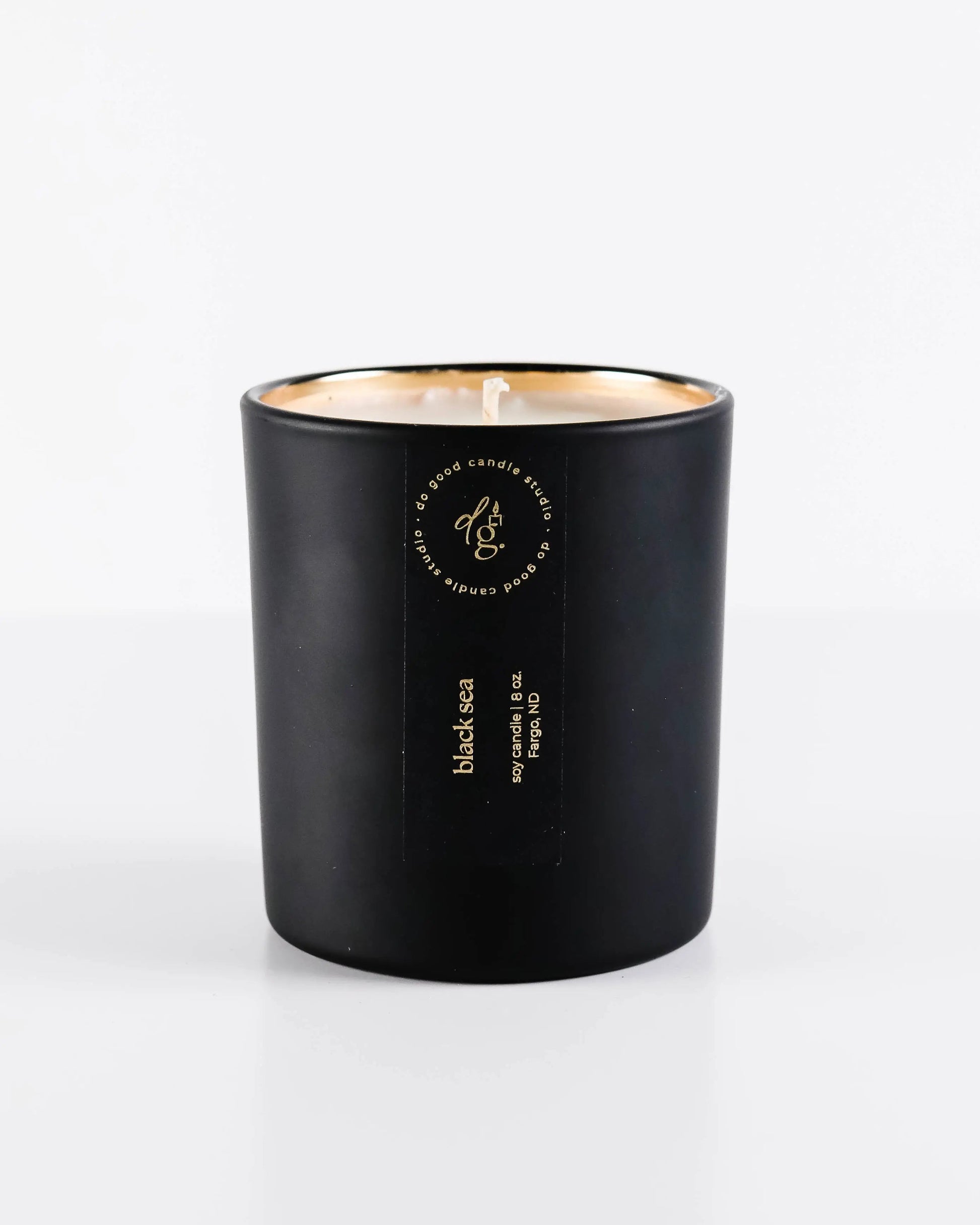 Black candle with a gold interior on a white background