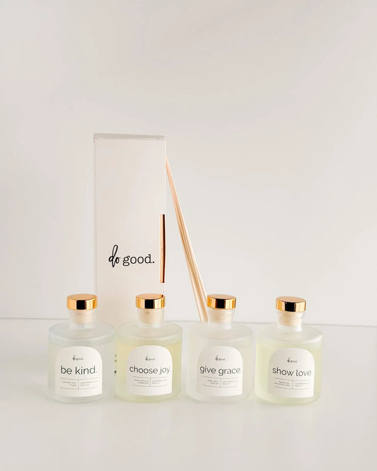 Do Good Collection Reed diffusers in a line with box and reeds in the background