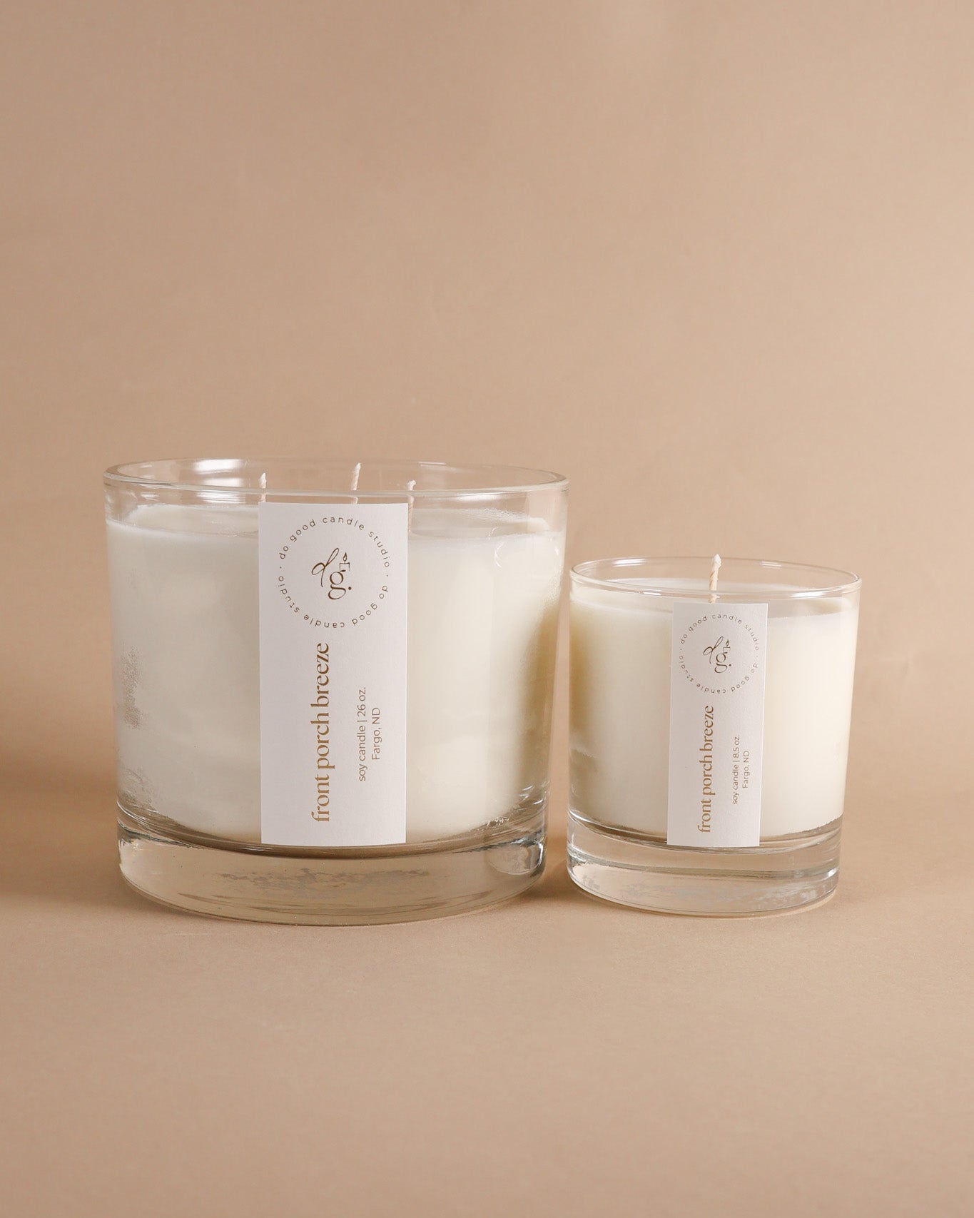 Front Porch Breeze triple wick and 8.5 ounce candle together on beige background