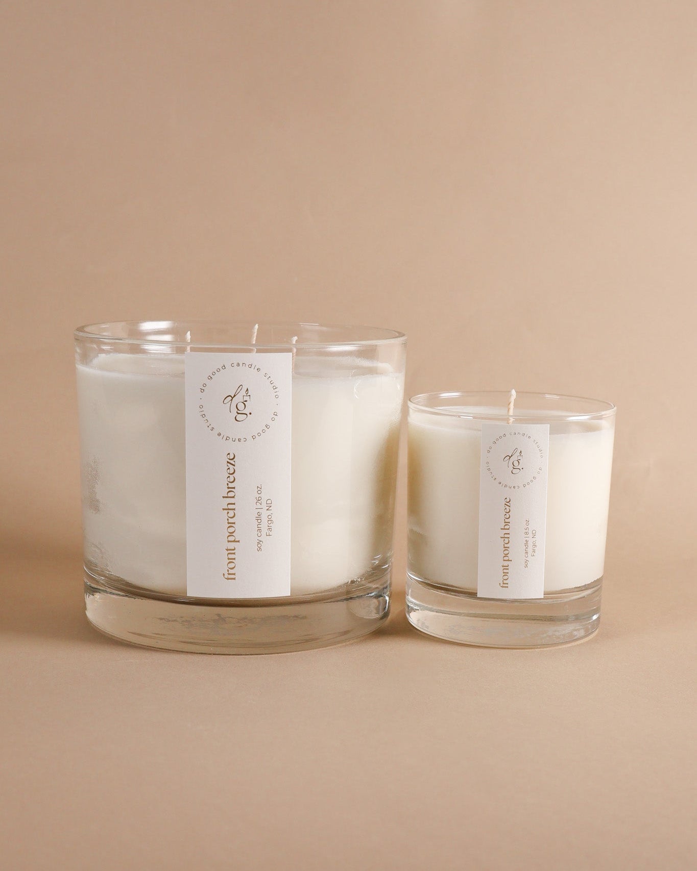 Front Porch Breeze Triple-Wick and 8.5 oz soy candle together on beige background