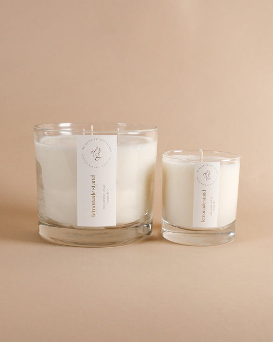 Lemonade stand triple wick and 8.5 ounce candles together on beigh background