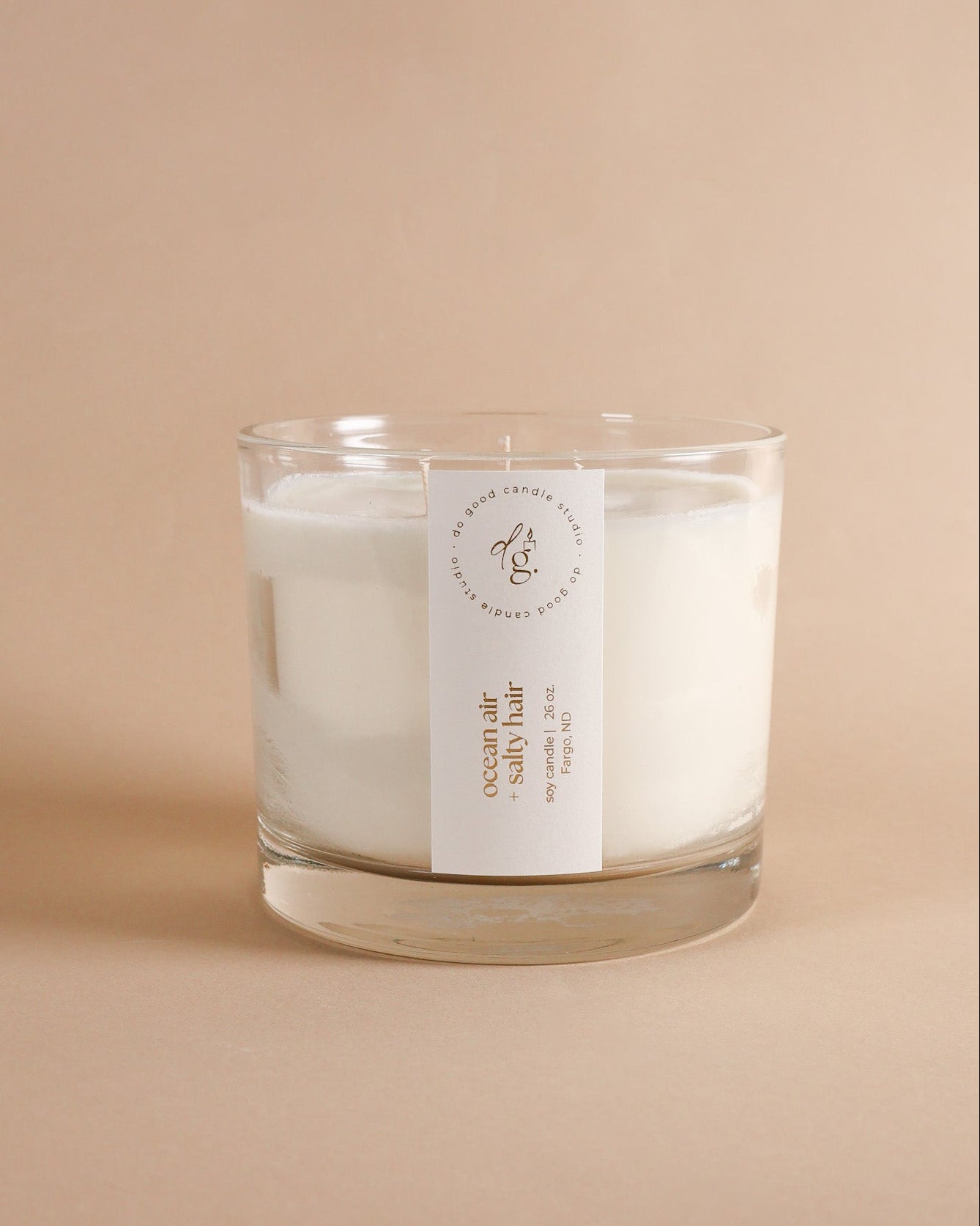 Triple wick ocean air + salty hair candle on beigh backdrop