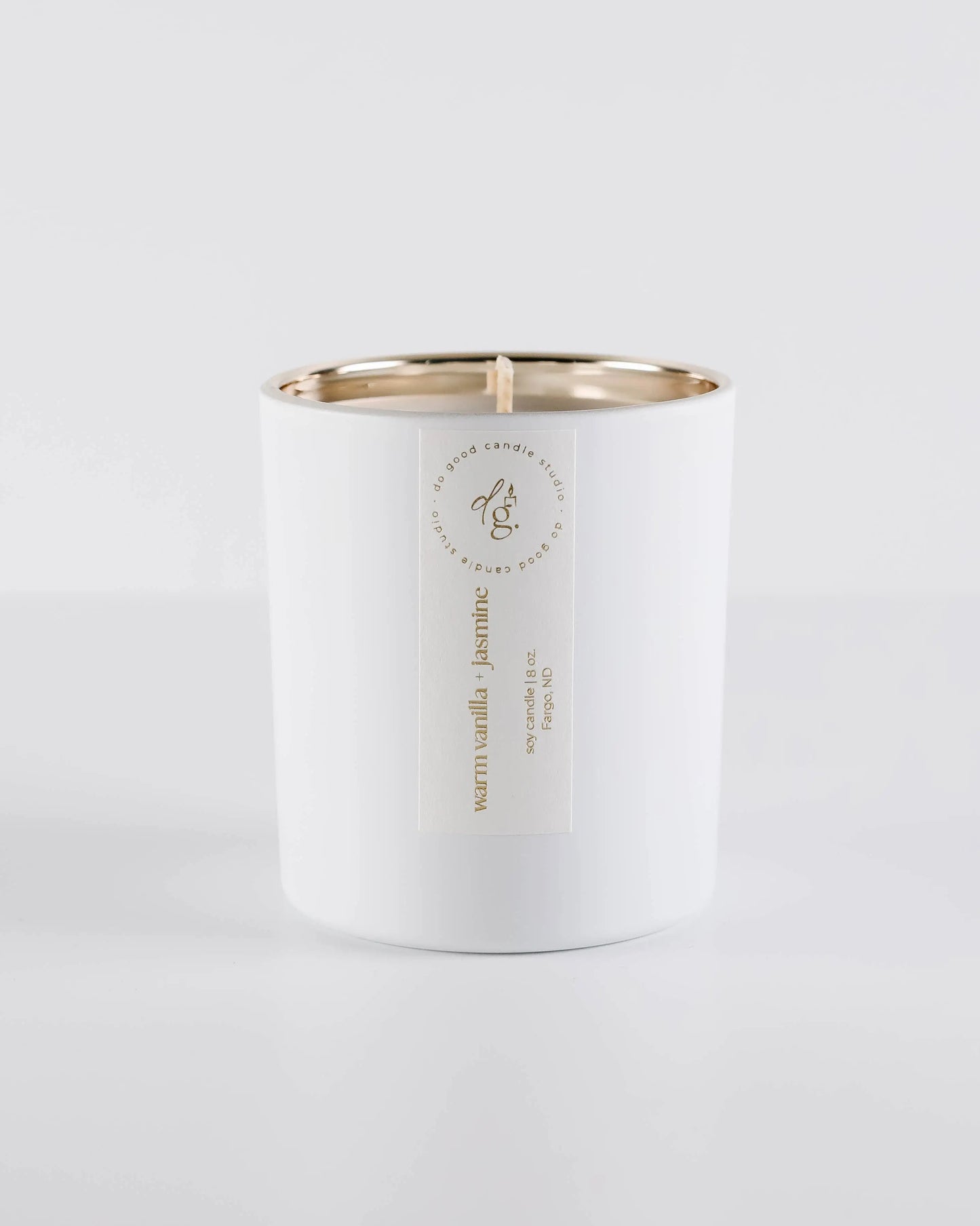 Warm Vanilla + Jasmine candle on a white backdrop
